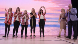 The women's soccer team waves to the crowd after winning the a contest at Dine and Bid.