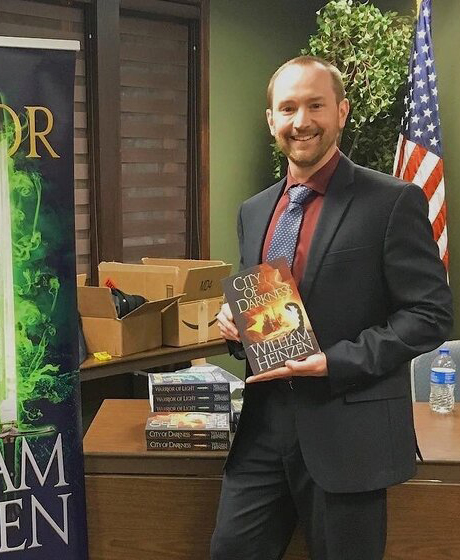 Bill Heinzen posing with his book