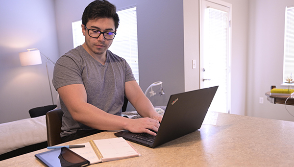 A man works on a laptop computer