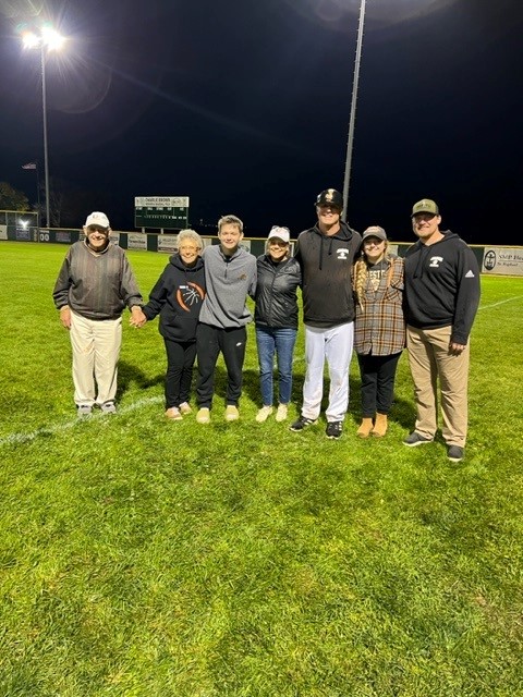 Tom and Judy with friends and family at baseball field.