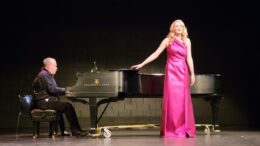 Photo of Melissa McCann singing while John Clodfelter plays piano.