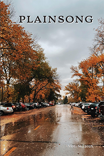 Student crossing campus street on a fall rainy day.