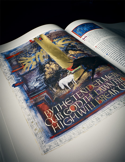 The birth of Jesus Christ is depicted in an illuminated manuscript with a scene in a stable and the words "BY THE TENDER MERCY, OUR GOD, THE DAWN FROM HIGH WILL BREAK."