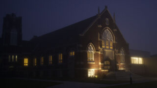 A chapel is blurred by fog in an early morning.