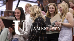 A group of women read music and sing together.