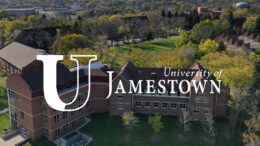 Aerial photo of college campus with white University of Jamestown Logo