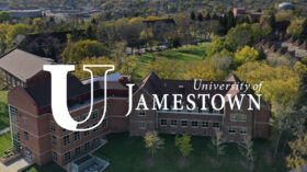 Aerial photo of college campus with white University of Jamestown Logo
