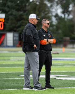 Dosch and Mistro stand on football field