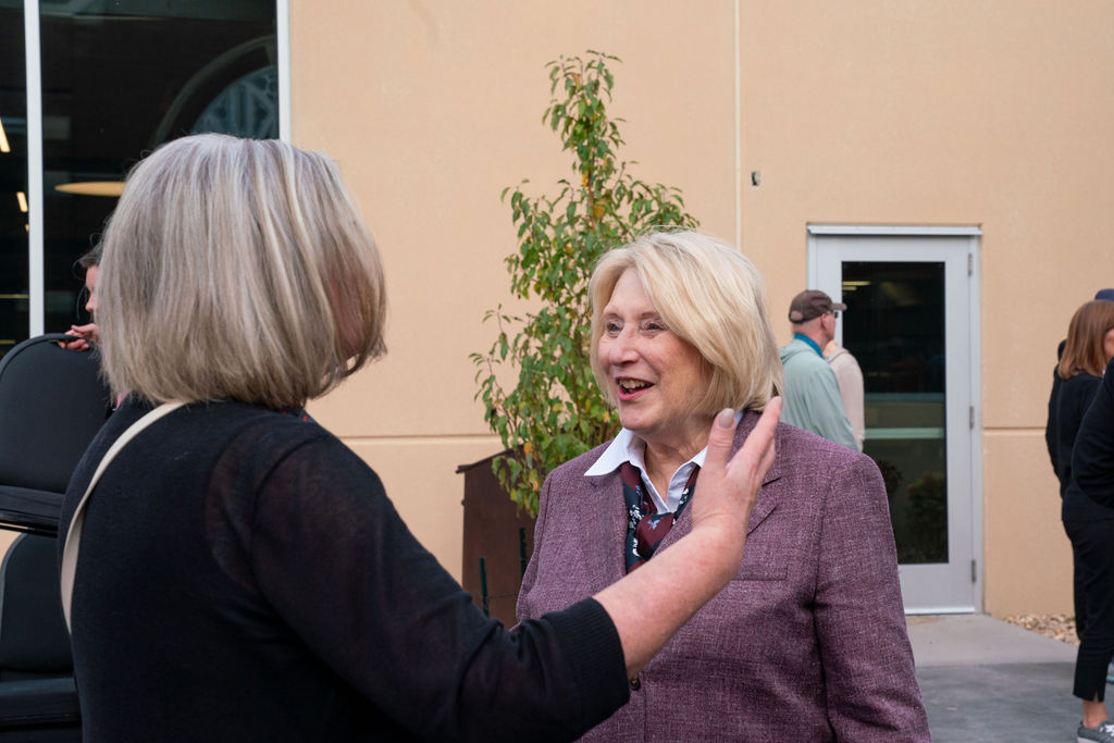 Candy Unruh visits with guest in the new Candy Unruh Garden