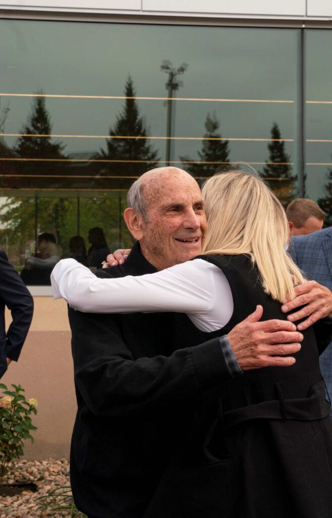 A man and woman embrace following dedication ceremony